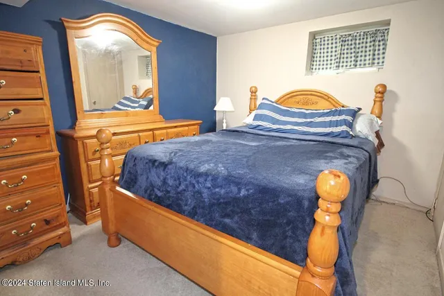 a bedroom with bed and window