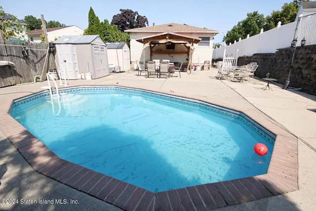 an outdoor space with swimming pool and furniture