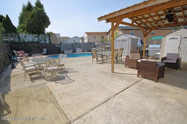 a view of a patio with couches table and chairs and potted plants
