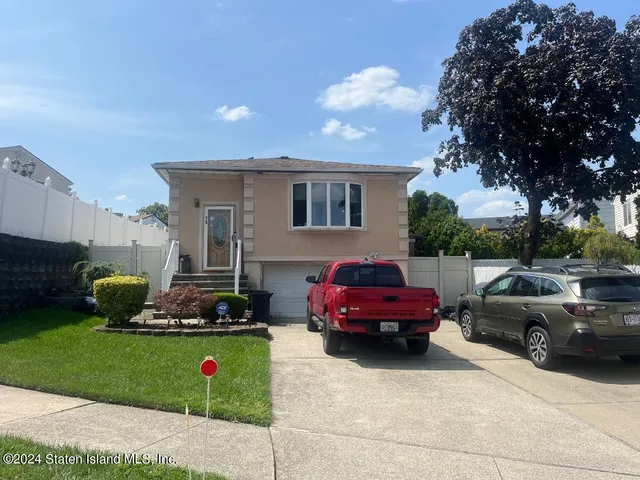 a front view of a house with car parked
