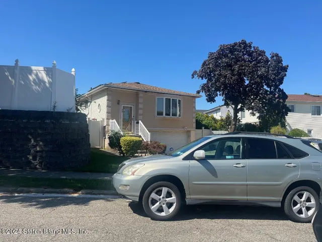 a front view of a house with parking space