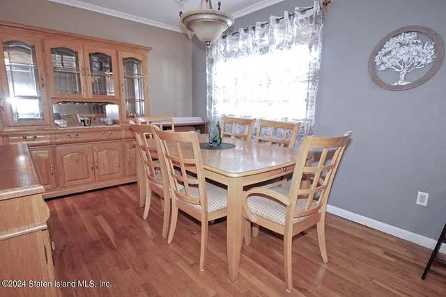 a dining room with furniture a chandelier and wooden floor