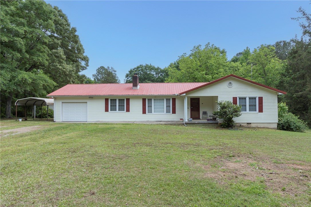 1116 Leatherdale Road Iva, SC 29655 - Photo 44 of 46 This charming home features a red metal roof and a spacious front yard, offering a tranquil retreat.