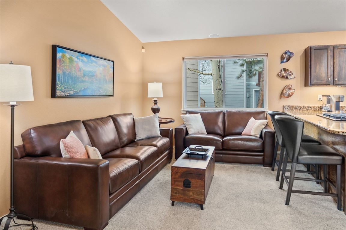 588 Alpine Road Dillon, CO 80435 - Photo 8 of 41 Living room with light colored carpet and lofted ceiling