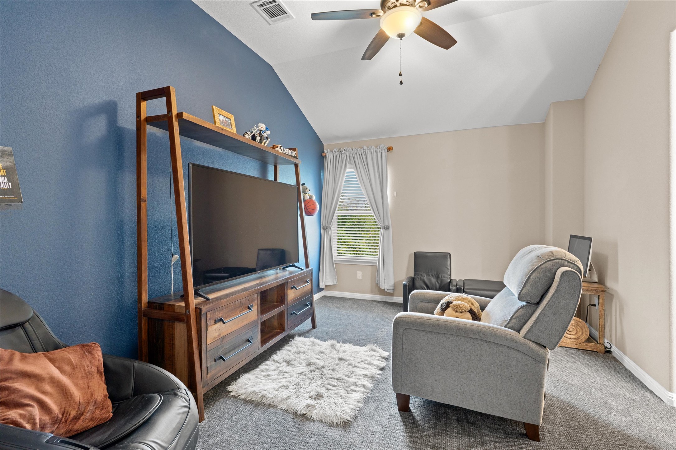 7716 Aria Loop Austin, TX 78736 - Photo 24 of 39 A vaulted ceiling enhances the spacious feel of this cozy living area, complete with comfortable seating and a window offering natural illumination.