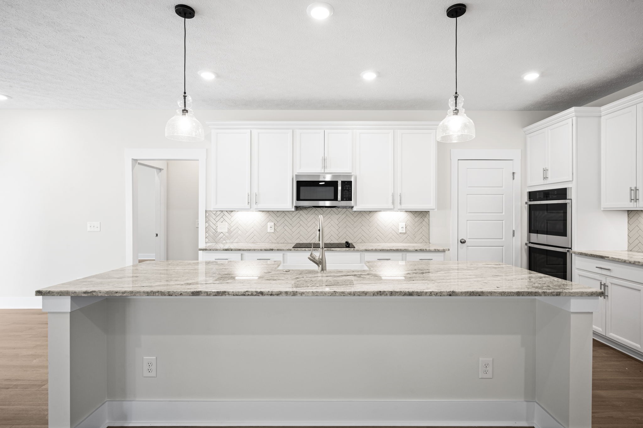 48 Powell Road Clarksville, TN 37043 - Photo 14 of 54 a kitchen with kitchen island granite countertop stainless steel appliances a sink a stove a microwave and a counter top space
