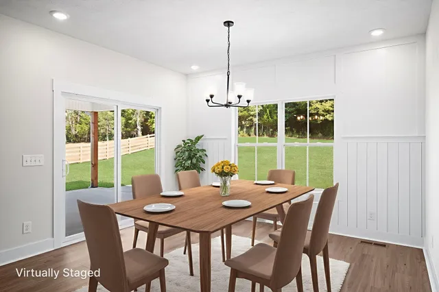 a view of a dining room with furniture window and wooden floor