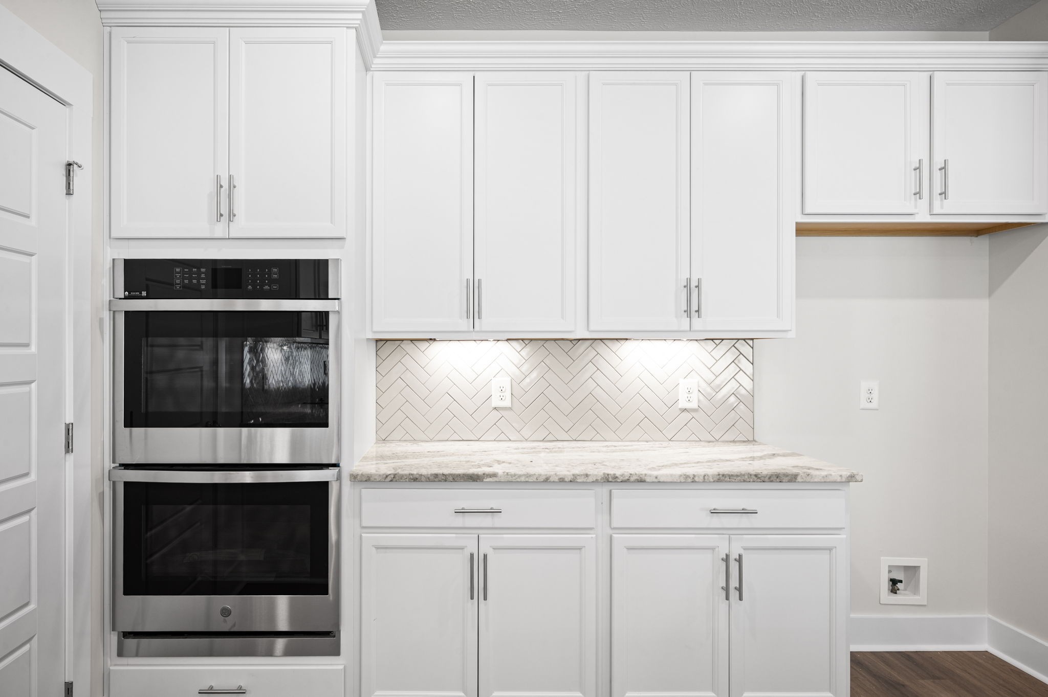 48 Powell Road Clarksville, TN 37043 - Photo 19 of 55 a kitchen with granite countertop white cabinets and stainless steel appliances