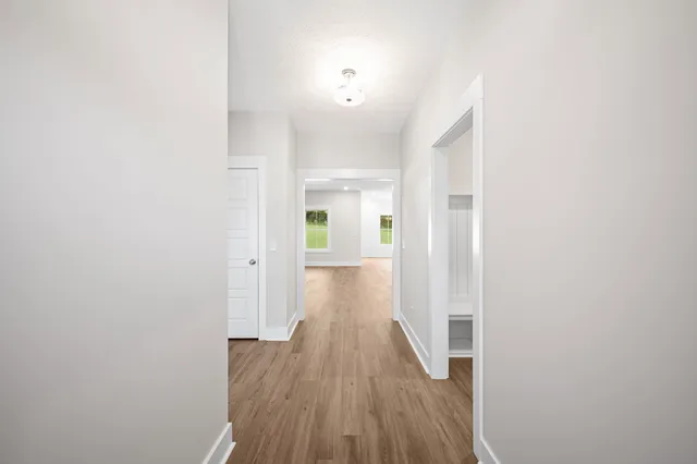 a view of a hallway with wooden floor