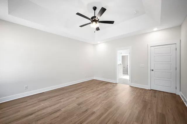 a bed room with a bed and a ceiling fan