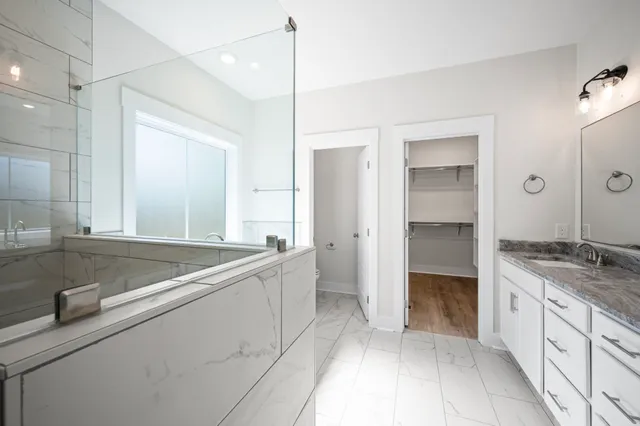 a bathroom with a sink a toilet and window