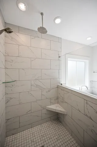 a bathroom with a bathtub and a shower