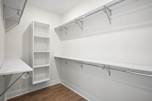 a view of walk in closet with empty racks
