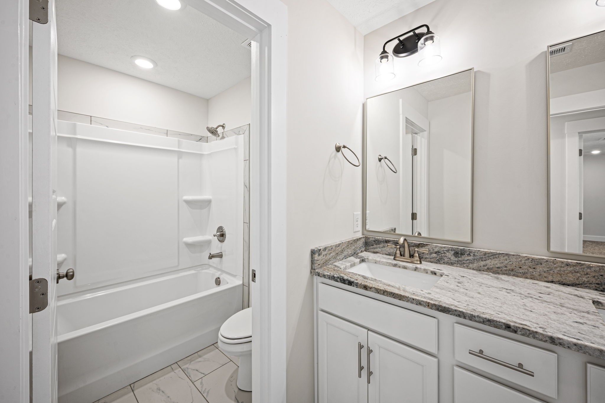 48 Powell Road Clarksville, TN 37043 - Photo 38 of 54 a bathroom with a granite countertop sink a toilet and shower