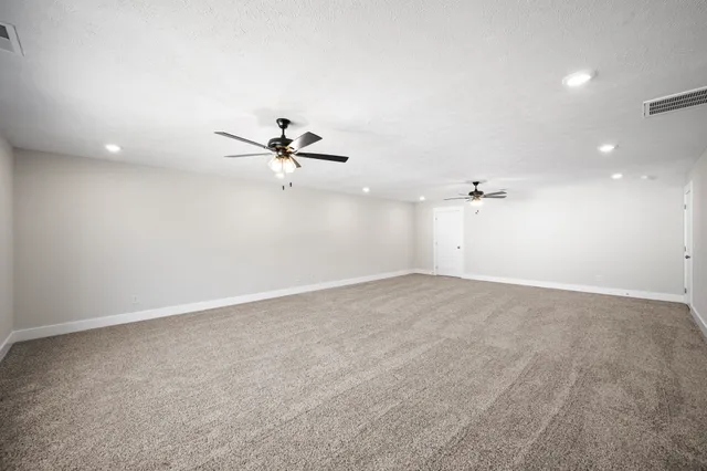 a bedroom with a bed tv and a window