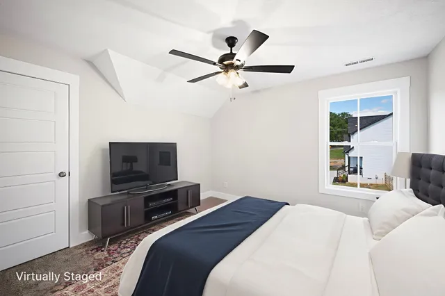 a view of a house with a big yard potted plants and large tree