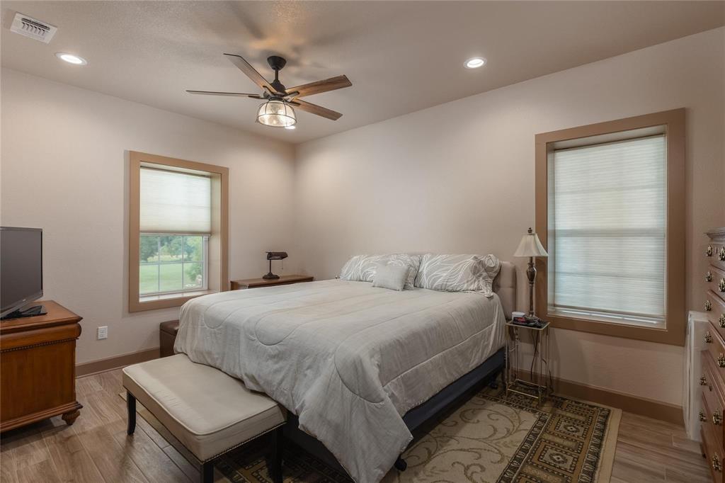 210 Spring Branch Trail North Springtown, TX 76082 - Photo 12 of 36 Room featuring wood-finish flooring, recessed lighting, and a ceiling fan with a bronze and glass fixture
