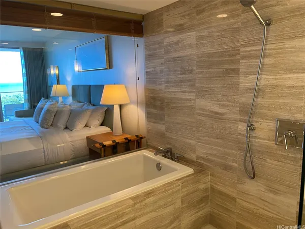 a bedroom with a bed and a lamp