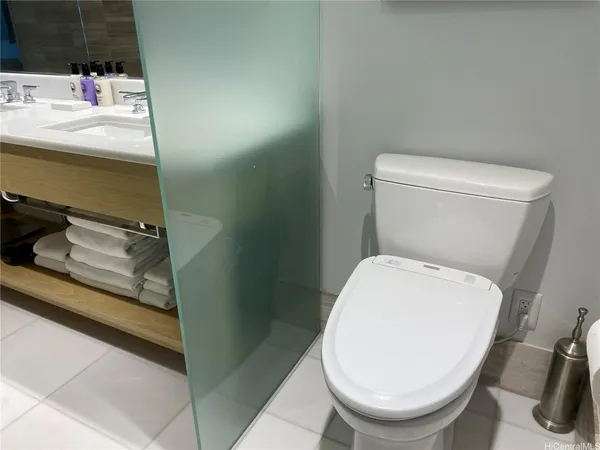 a white toilet sitting next to a bathroom sink
