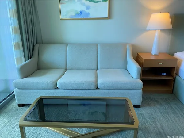 a living room with furniture and a lamp