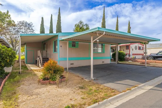 a view of a house with a porch and furniture