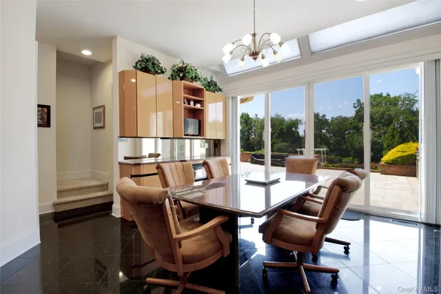a dining room with furniture a chandelier and wooden floor