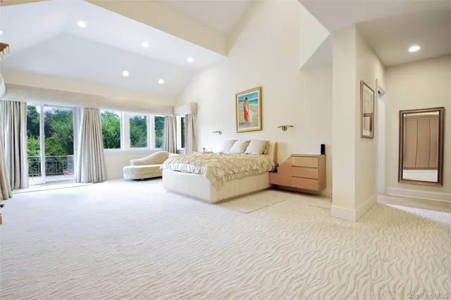 a spacious bedroom with a bed and a large window