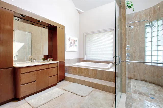 a bathroom with a tub sink and mirror