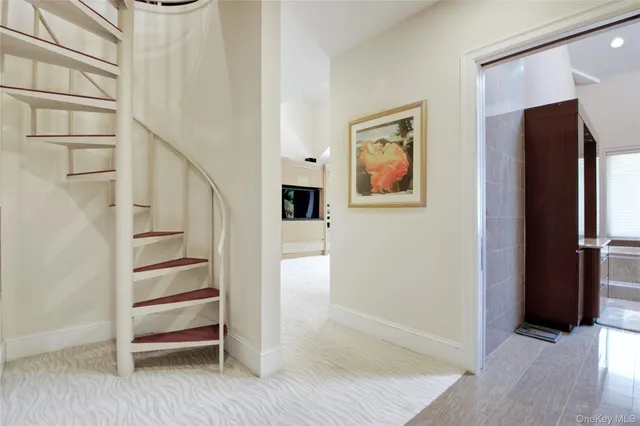 a view of a hallway with wooden floor and entryway