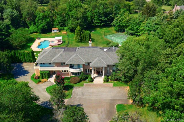an aerial view of a house with yard swimming pool and outdoor seating