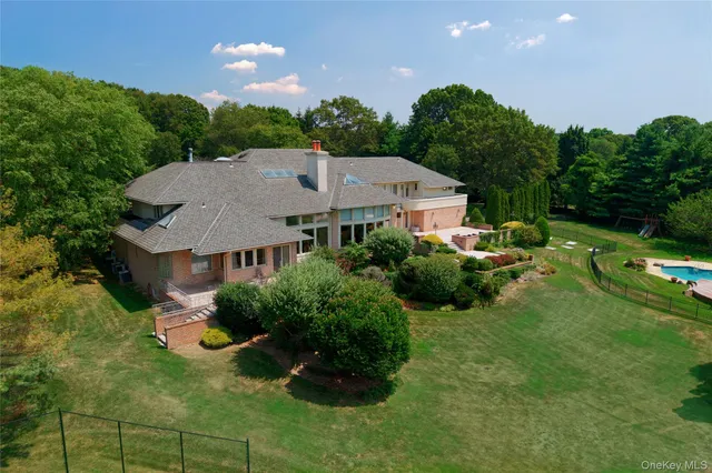 a aerial view of a house with swimming pool and garden
