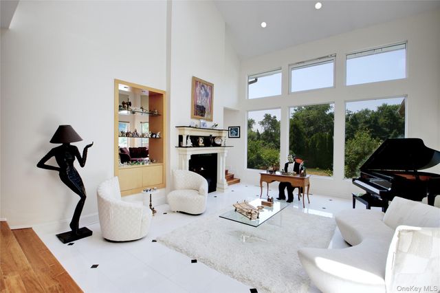 a living room with furniture a rug floor and a large window