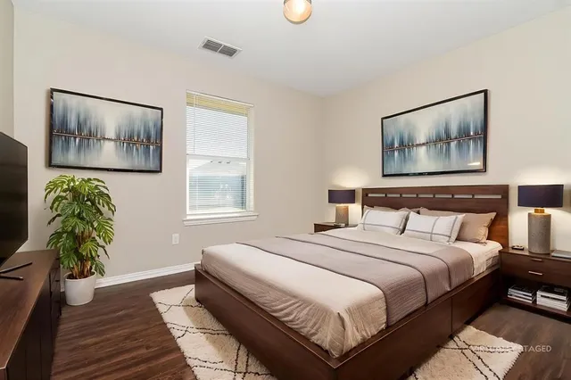 a bedroom with bed and window