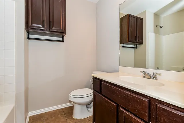 a bathroom with a sink a toilet and mirror