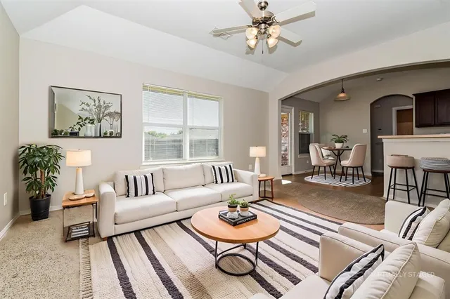 a living room with furniture and a large window