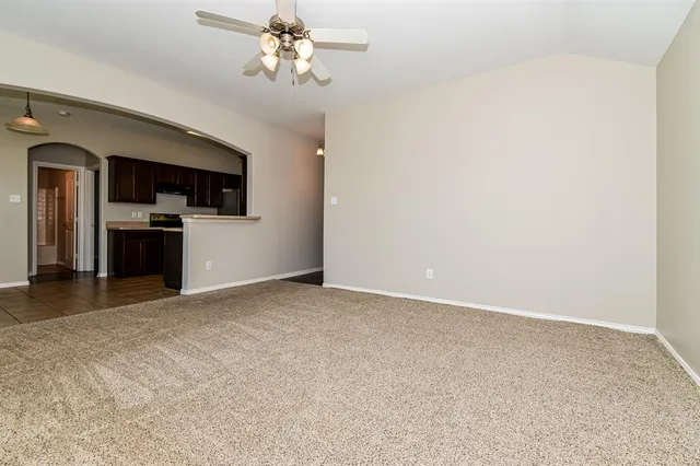 a view of a kitchen with a sink and a refrigerator