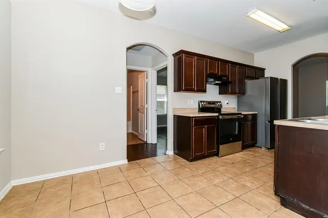 a kitchen with stainless steel appliances a refrigerator and a sink