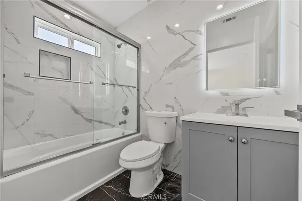 a bathroom with a toilet sink and shower