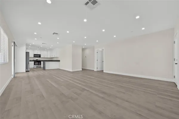 a view of a kitchen with a refrigerator and a sink