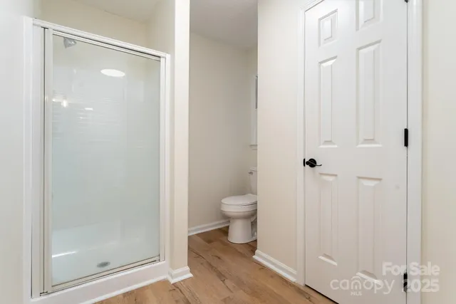 a bathroom with a glass shower door