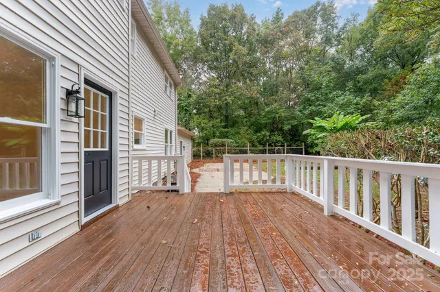 a view of wooden balcony and trees