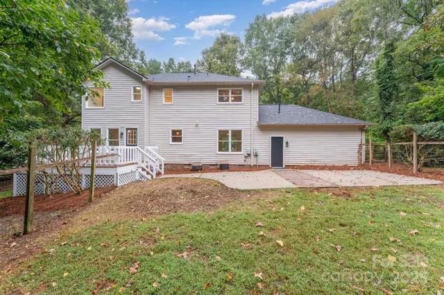 a backyard of a house with table and chairs