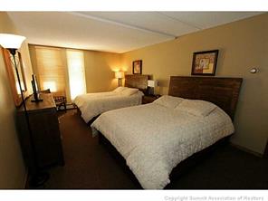 800 Copper Road, Unit 173 Copper Mountain, CO 80443 - Photo 14 of 17 a bedroom with two beds and a large mirror