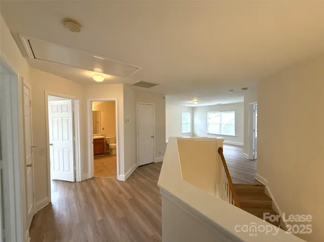 a view of a kitchen with furniture and wooden floor