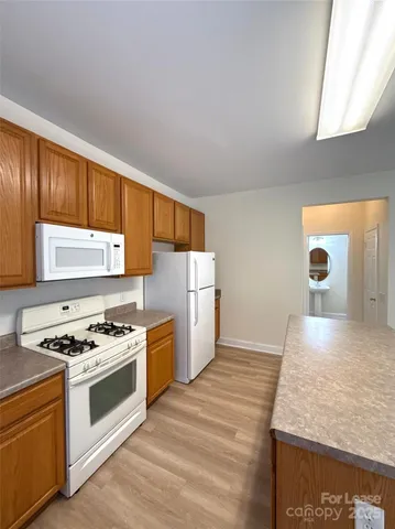 a kitchen with granite countertop a stove and a sink
