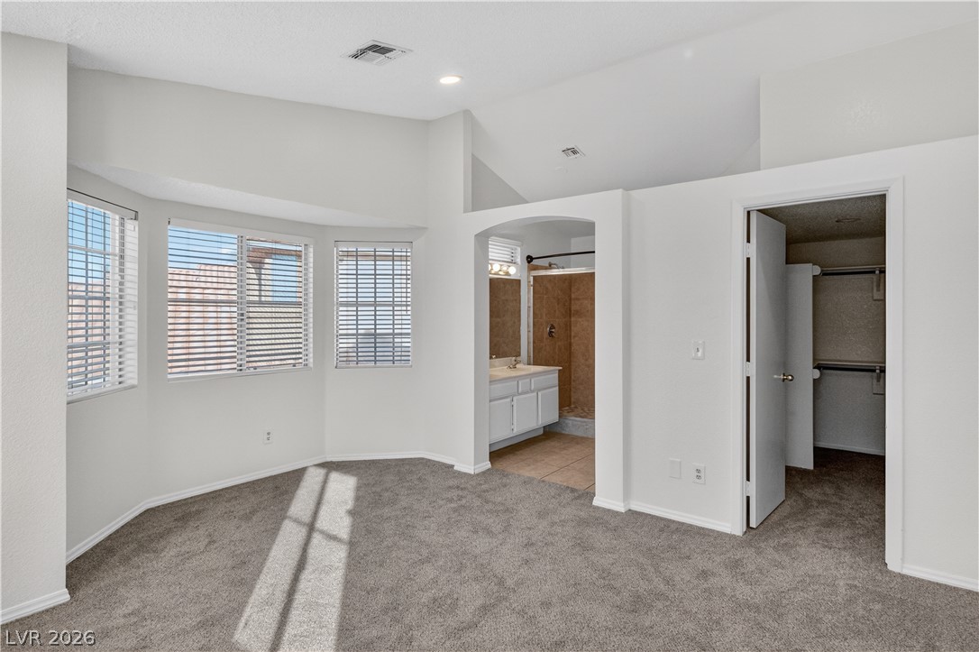 3156 Terrace View Drive Laughlin, NV 89029 - Photo 30 of 94 A spacious bedroom offers a large bay window, soft carpet, and convenient access to an en-suite bath.