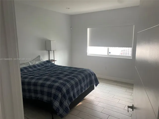 a bedroom with a bed and window