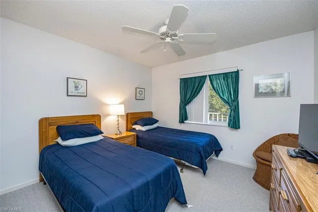 a bedroom with two beds and painting on the wall