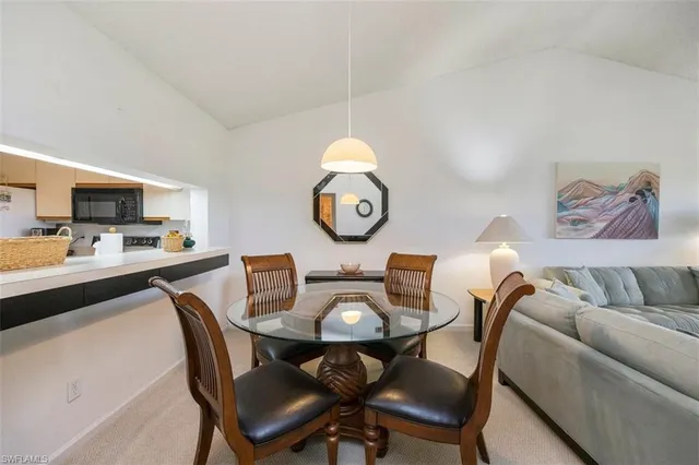 a view of a dining room with furniture and window