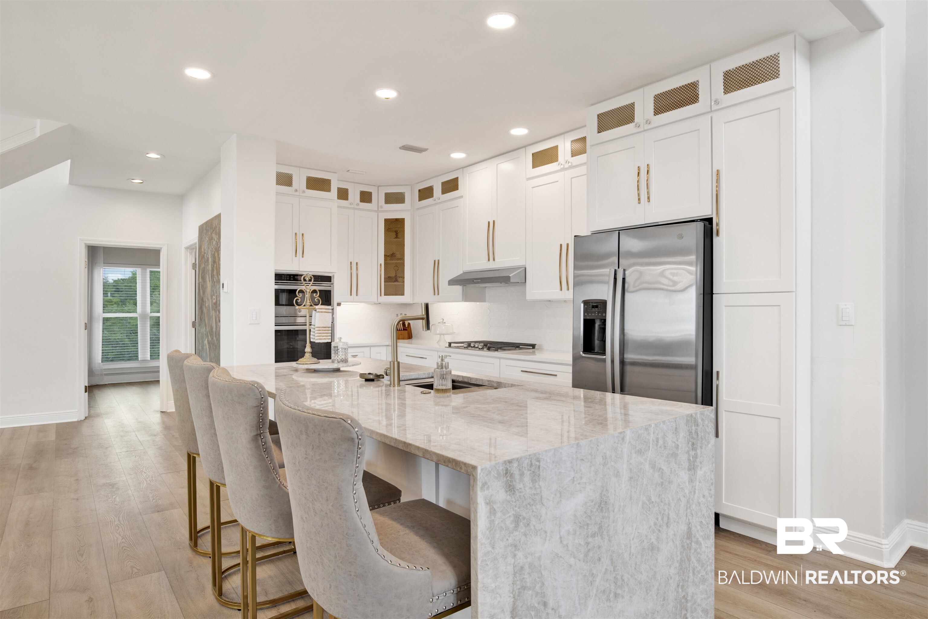 30351 River Road Orange Beach, AL 36561 - Photo 9 of 44 Waterfall island with a light-toned stone surface, providing integrated seating